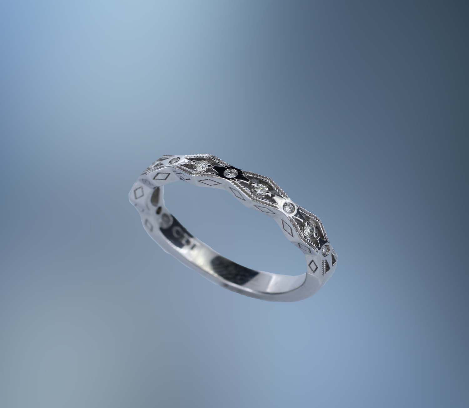 14KT WHITE GOLD DIAMOND ANNIVERSARY BAND FEATURING 11 ROUND BRILLIANT CUT DIAMONDS TOTALING 0.09 CTS 14KT WHITE GOLD DIAMOND ANNIVERSARY BAND FEATURING 11 ROUND BRILLIANT CUT DIAMONDS TOTALING 0.09 CTS