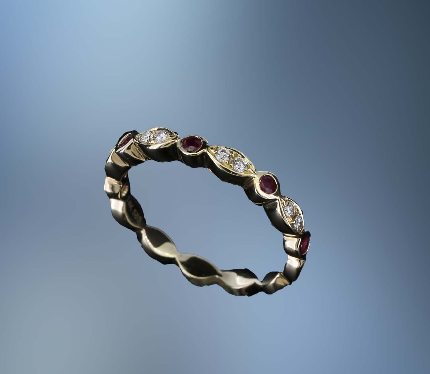 14KT YELLOW GOLD DIAMOND & RUBY BAND FEATURING 5 RUBIES TOTALING 0.17 CTS & 8 ROUND BRILLIANT CUT DIAMONDS TOTALING 0.10 CTS 14KT YELLOW GOLD DIAMOND & RUBY BAND FEATURING 5 RUBIES TOTALING 0.17 CTS & 8 ROUND BRILLIANT CUT DIAMONDS TOTALING 0.10 CTS