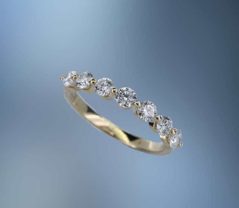 14KT YELLOW GOLD DIAMOND WEDDING BAND FEATURING 7 ROUND BRILLIANT DIAMONDS TOTALING 0.74 CTS