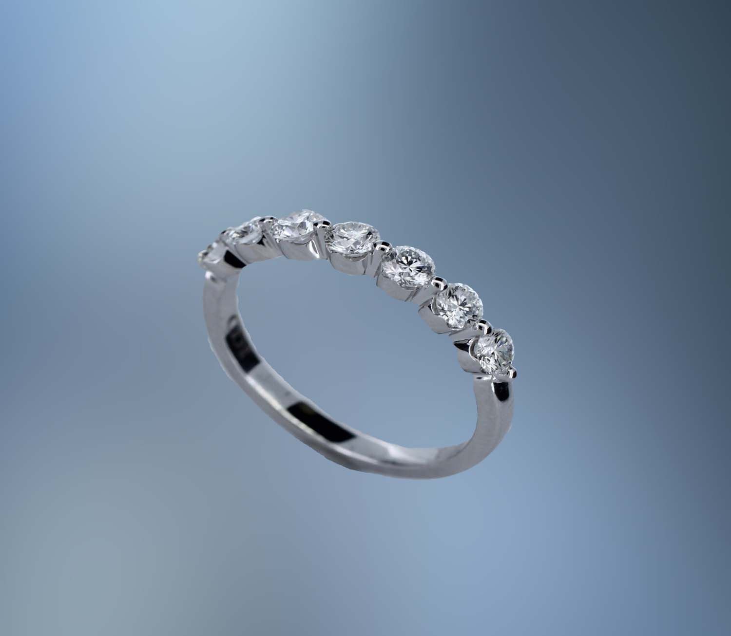14KT WHITE GOLD DIAMOND WEDDING BAND FEATURING 7 ROUND BRILLIANT DIAMONDS TOTALING 0.74 CTS