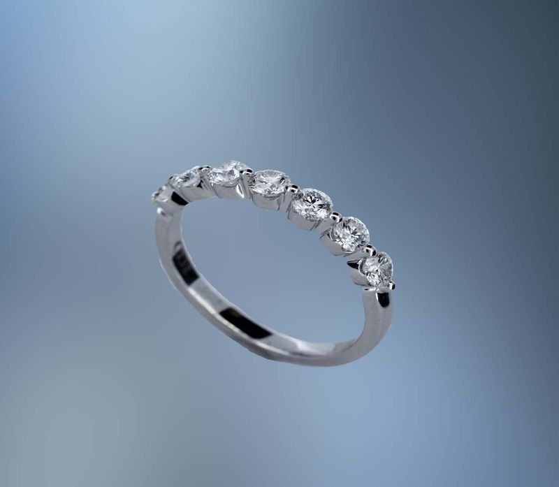 14KT WHITE GOLD DIAMOND WEDDING BAND FEATURING 7 ROUND BRILLIANT DIAMONDS TOTALING 0.74 CTS