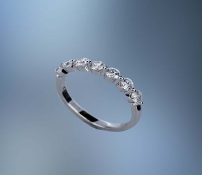 14KT WHITE GOLD DIAMOND WEDDING BAND FEATURING 7 ROUND BRILLIANT DIAMONDS TOTALING 0.74 CTS