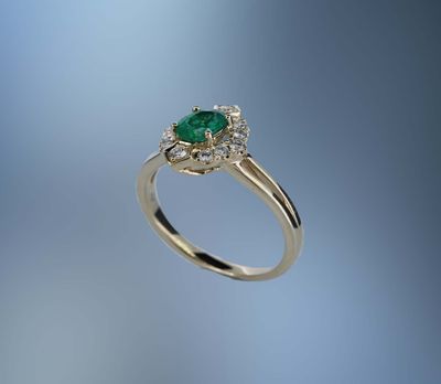 14 KARAT YELLOW GOLD EMERALD AND DIAMOND FASHION RING CONTAINING 1 OVAL SHAPE EMERALD WEIGHING 0.56 CARATS AND 12 ROUND BRILLIANT CUT DIAMONDS WEIGHING 0.24 CARATS