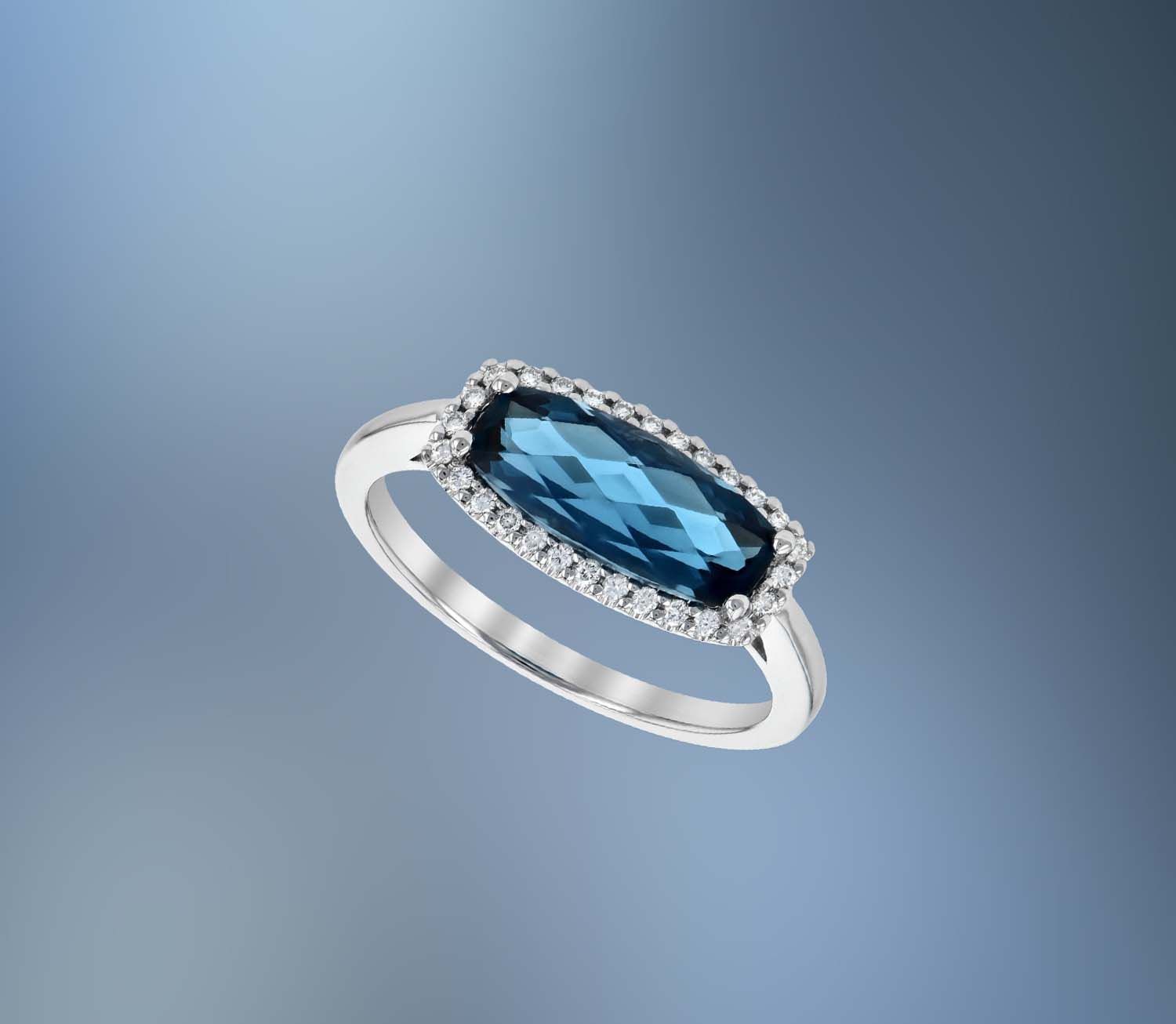 14KT WHITE GOLD BLUE TOPAZ AND DIAMOND FASHION RING FEATURING ROUND BRILLIANT CUT DIAMONDS TOTALING 0.11 CTS 14KT WHITE GOLD BLUE TOPAZ AND DIAMOND FASHION RING FEATURING ROUND BRILLIANT CUT DIAMONDS TOTALING 0.11 CTS