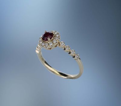 14 KARAT YELLOW GOLD RUBY AND DIAMOND FASHION RING CONTAINING 1 ROUND RUBY WEIGHING 0.41 CARATS AND 21 ROUND BRILLIANT CUT DIAMONDS TOTALING 0.23 CARATS 14 KARAT YELLOW GOLD RUBY AND DIAMOND FASHION RING CONTAINING 1 ROUND RUBY WEIGHING 0.41 CARATS AND 21 ROUND BRILLIANT CUT DIAMONDS TOTALING 0.23 CARATS