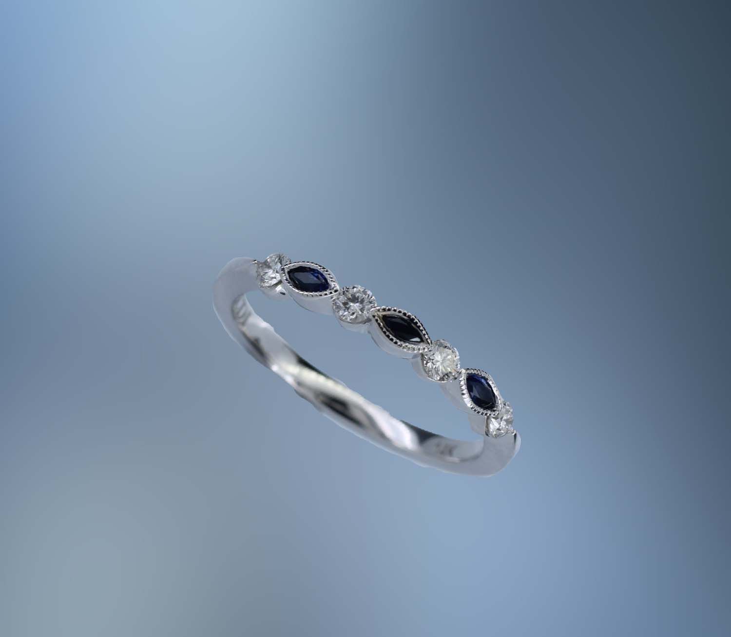 14KT WHITE GOLD DIAMOND & SAPPHIRE BAND CONTAINING 4 ROUND BRILLIANT DIAMONDS TOTALING .19 CTS & 3 MARQ SAPHIRES TOTALING .14 CTS 14KT WHITE GOLD DIAMOND & SAPPHIRE BAND CONTAINING 4 ROUND BRILLIANT DIAMONDS TOTALING .19 CTS & 3 MARQ SAPHIRES TOTALING .14 CTS