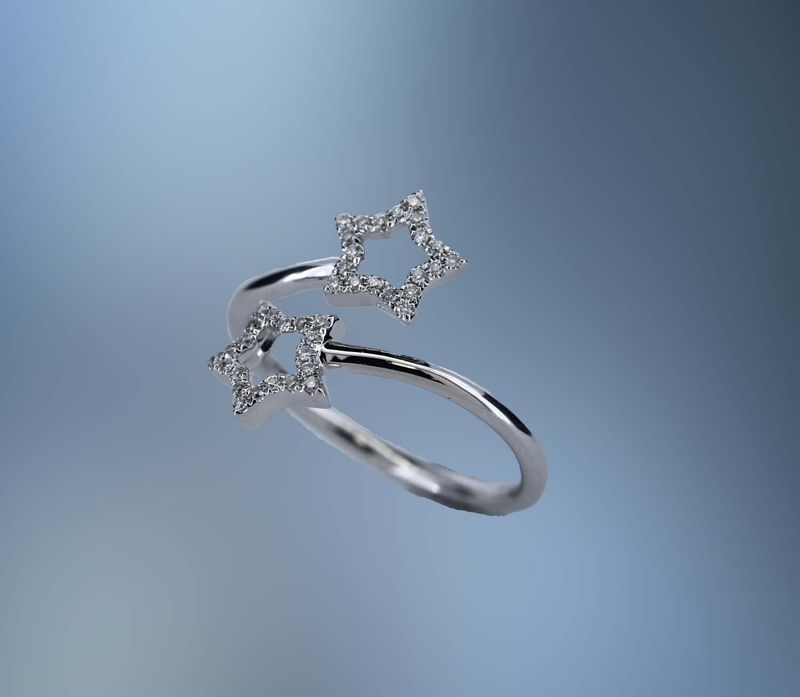 14KT WHITE GOLD DIAMOND STAR BYPASS RING FEATURING 40 ROUND BRILLIANT CUT DIAMONDS TOTALING .12 CTS