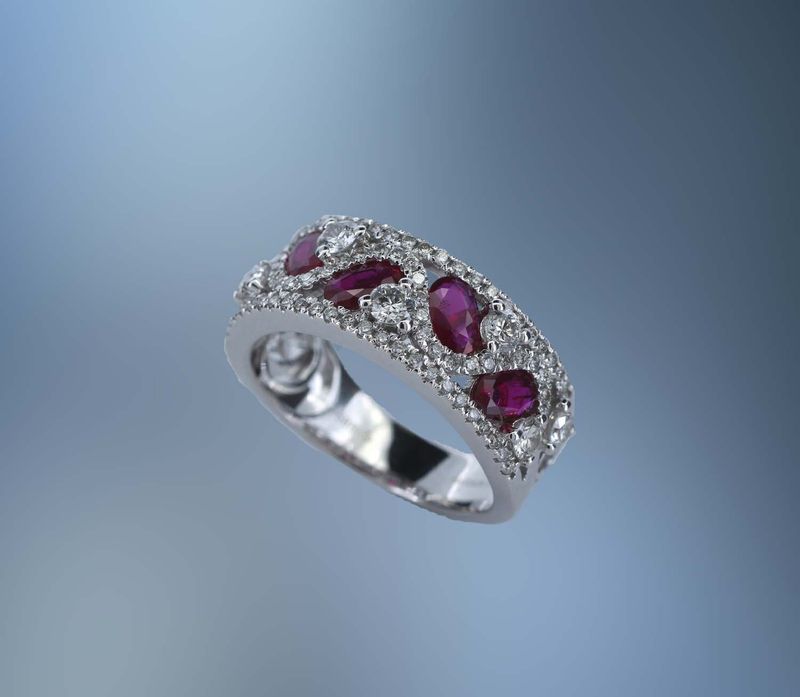 14KT WHITE GOLD FASHION RING FEATURING 5 OVAL BRILLIANT CUT RUBY'S TOTALING 1.10 CTS , AND 90 ROUND BRILLIANT CUT DIAMONDS TOTALING .86 CTS