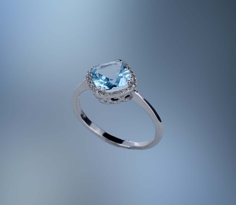 14KT WHITE GOLD FASHION  RING FEATURING (1) CUSHION CUT 1.75 CT. BLUE TOPAZ AND 24 ROUND BRILLIANT CUT DIAMONDS TOTALING  .07 CTS.