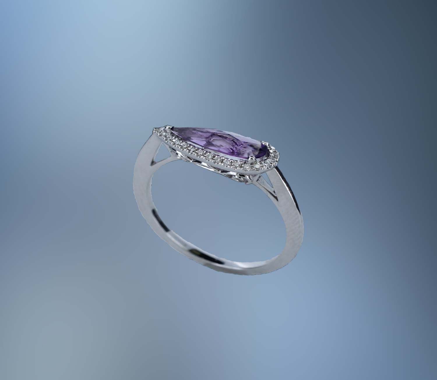 14KT WHITE GOLD RING FEATURING 1 FANTASY CUT AMETHYST TOTALING 1.10 CTS AND 29 ROUND BRILLIANT CUT DIAMONDS TOTALING .08 CTS