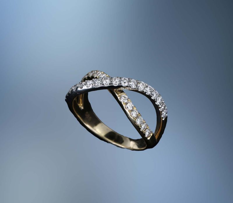 14KT WHITE & YELLOW GOLD CRISS CROSS  DIAMOND FASHION RING FEATURING  29 ROUND BRILLIANT DIAMONDS TOTALING 0.62 CTS