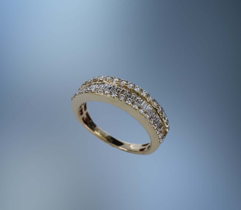 14KT YELLOW GOLD DIAMOND WEDDING BAND FEATURING 38  ROUND  BRILLIANT CUT DIAMONDS AND 24 BAGUETTES, TOTALING .95 CTS.