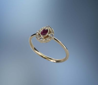 14KT YELLOW GOLD RUBY AND DIAMOND RING FEATURING  ONE .18 CT. OVAL BRILLIANT CUT RUBY AND 16 ROUND BRILLIANT CUT DIAMONDS TOTALING .09 CTS.