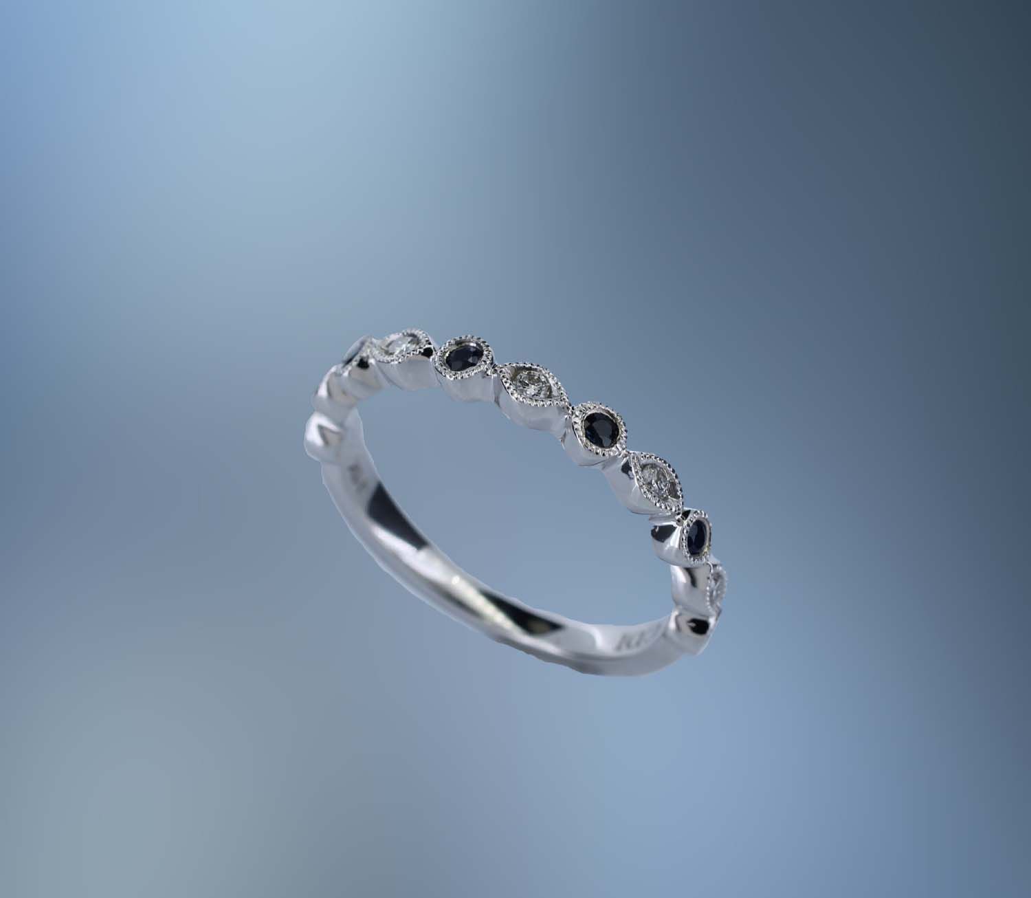ONE 14KT WHITE GOLD LADIES BLUE SAPPHIRE AND DIAMOND RING CONTAINING .08 CTS. OF ROUND BRILLIANT CUT NATURAL DIAMONDS, AND .18 CTS. OF ROUND BRILLIANT CUT SAPPHIRES. ONE 14KT WHITE GOLD LADIES BLUE SAPPHIRE AND DIAMOND RING CONTAINING .08 CTS. OF ROUND BRILLIANT CUT NATURAL DIAMONDS, AND .18 CTS. OF ROUND BRILLIANT CUT SAPPHIRES. 