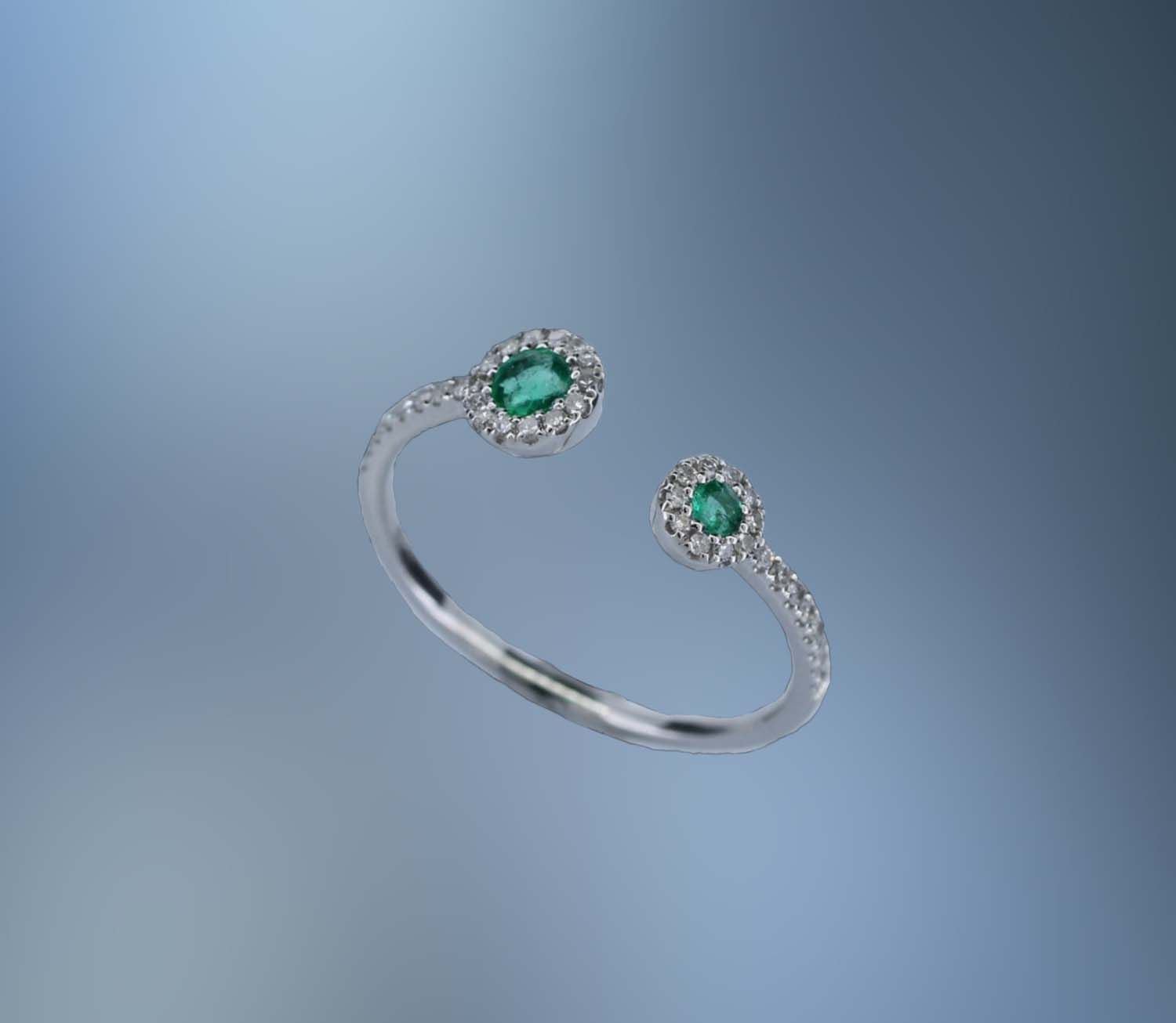 ONE 14KT WHITE GOLD LADYS NATURAL EMERALD AND DIAMOND RING CONTAINING .13 CTTW OF NATURAL SINGLE CUT DIAMONDS AND TWO NATURAL ROUND BRILLIANT CUT EMERALDS .15 CTTW ONE 14KT WHITE GOLD LADYS NATURAL EMERALD AND DIAMOND RING CONTAINING .13 CTTW OF NATURAL SINGLE CUT DIAMONDS AND TWO NATURAL ROUND BRILLIANT CUT EMERALDS .15 CTTW
