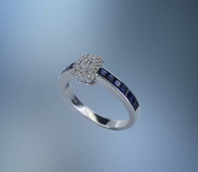 ONE 18KT WHITE GOLD LADIES DIAMOND AND SAPPHIRE RING CONTAINING .75 CTS. OF PRINCESS CUT NATURAL BLUE SAPPHIRES AND .20 CTS OF NATURAL ROUND BRILLIANT CUT, PRINCESS CUT AND BAGUETTE DIAMONDS ONE 18KT WHITE GOLD LADIES DIAMOND AND SAPPHIRE RING CONTAINING .75 CTS. OF PRINCESS CUT NATURAL BLUE SAPPHIRES AND .20 CTS OF NATURAL ROUND BRILLIANT CUT, PRINCESS CUT AND BAGUETTE DIAMONDS 
