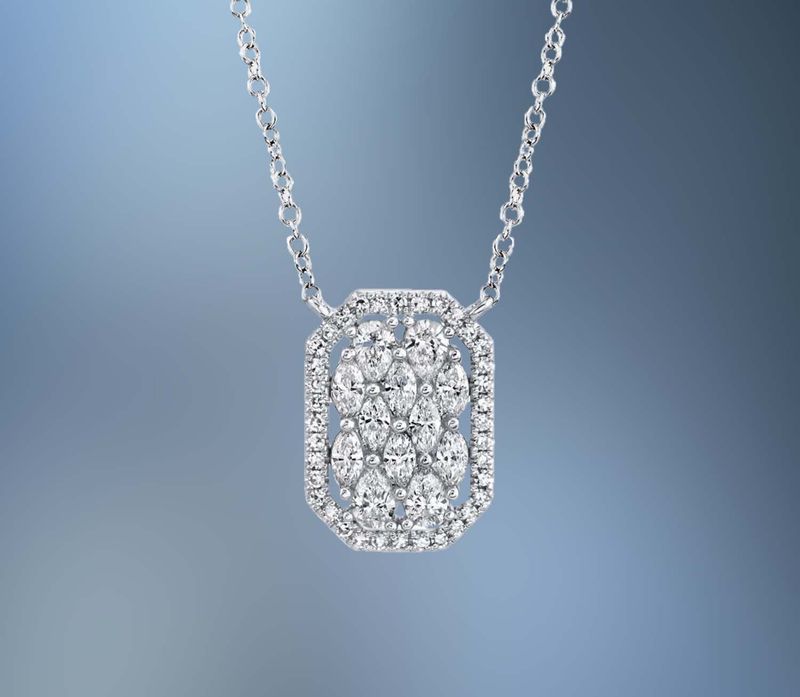 14KT WHITE GOLD DIAMOND PENDANT FEATURING 4 PEAR SHAPED DIAMONDS, 8 MARQUISE SHAPED DIAMONDS, AND 35 ROUND BRILLIANT CUT DIAMONDS TOTALING 0.62 CTS.