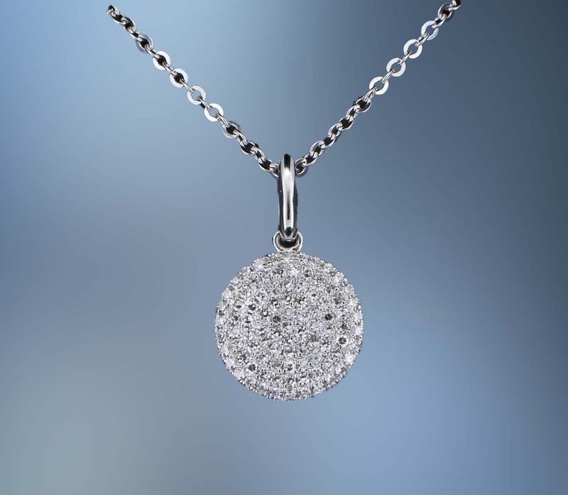 14KT WHITE GOLD DISC PENDANT FEATURING  ROUND BRILLIANT CUT DIAMONDS TOTALING 0.23 CTS