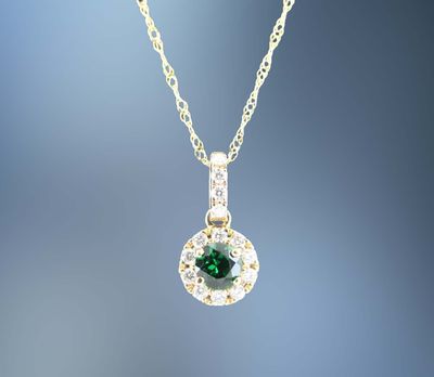 14 KARAT YELLOW GOLD TSAVORITE AND DIAMOND PENDANT CONTAINING ONE ROUND TSAVORITE GARNET WEIGHING .30 CARATS AND 14 ROUND BRILLIANT CUT DIAMONDS TOTALING .13 CARATS 14 KARAT YELLOW GOLD TSAVORITE AND DIAMOND PENDANT CONTAINING ONE ROUND TSAVORITE GARNET WEIGHING .30 CARATS AND 14 ROUND BRILLIANT CUT DIAMONDS TOTALING .13 CARATS