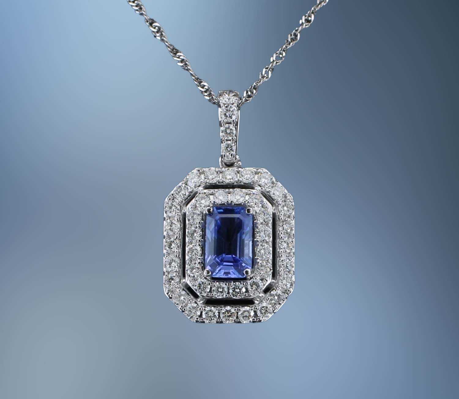 14KT WHITE GOLD DIAMOND & SAPPHIRE PENDANT FEATURING A SAPPHIRE TOTALING 0.60 CTS & DIAMONDS TOTALING 0.58 CTS 14KT WHITE GOLD DIAMOND & SAPPHIRE PENDANT FEATURING A SAPPHIRE TOTALING 0.60 CTS & DIAMONDS TOTALING 0.58 CTS