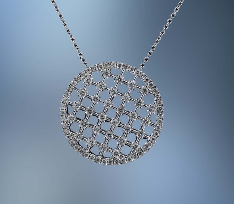 14KT WHITE GOLD DIAMOND CIRCLE PENDANT FEATURING 80 ROUND BRILLIANT DIAMONDS TOTALING .71 CTS