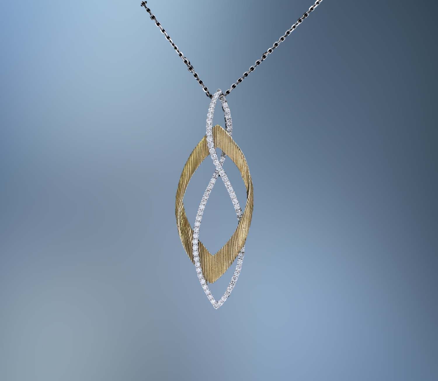 14KT TWO-TONE DIAMOND PENDANT FEATURING 76 ROUND BRILLIANT CUT DIAMONDS TOTALING 0.04 CTS.