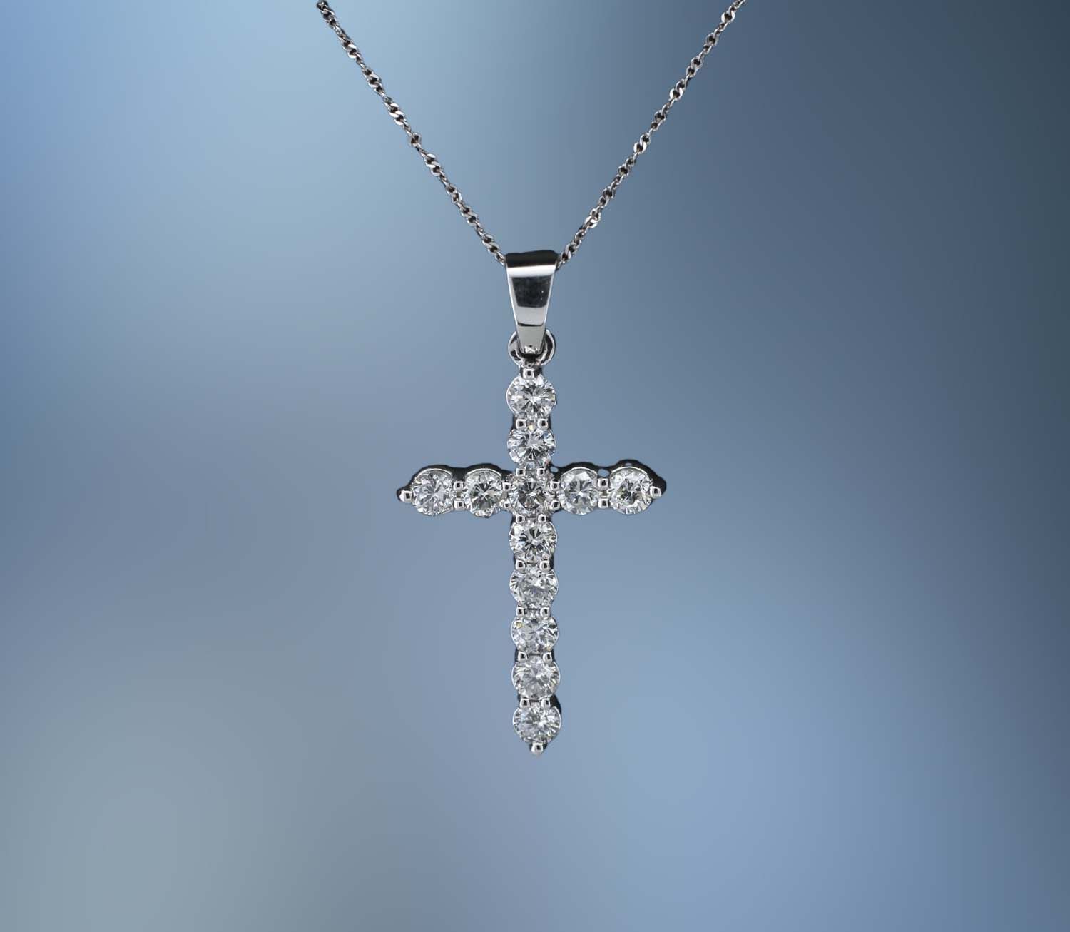 14KT WHITE GOLD DIAMOND CROSS PENDANT FEATURING 12 ROUND BRILLIANT DIAMONDS TOTALING 1.12 CTS