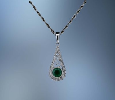 14KT WHITE GOLD LADY'S PENDANT FEATURING ONE ROUND BRILLIANT CUT EMERALD TOTALING .30 CTS AND 28 ROUND BRILLIANT CUT  DIAMOND TOTALING .12 CTS