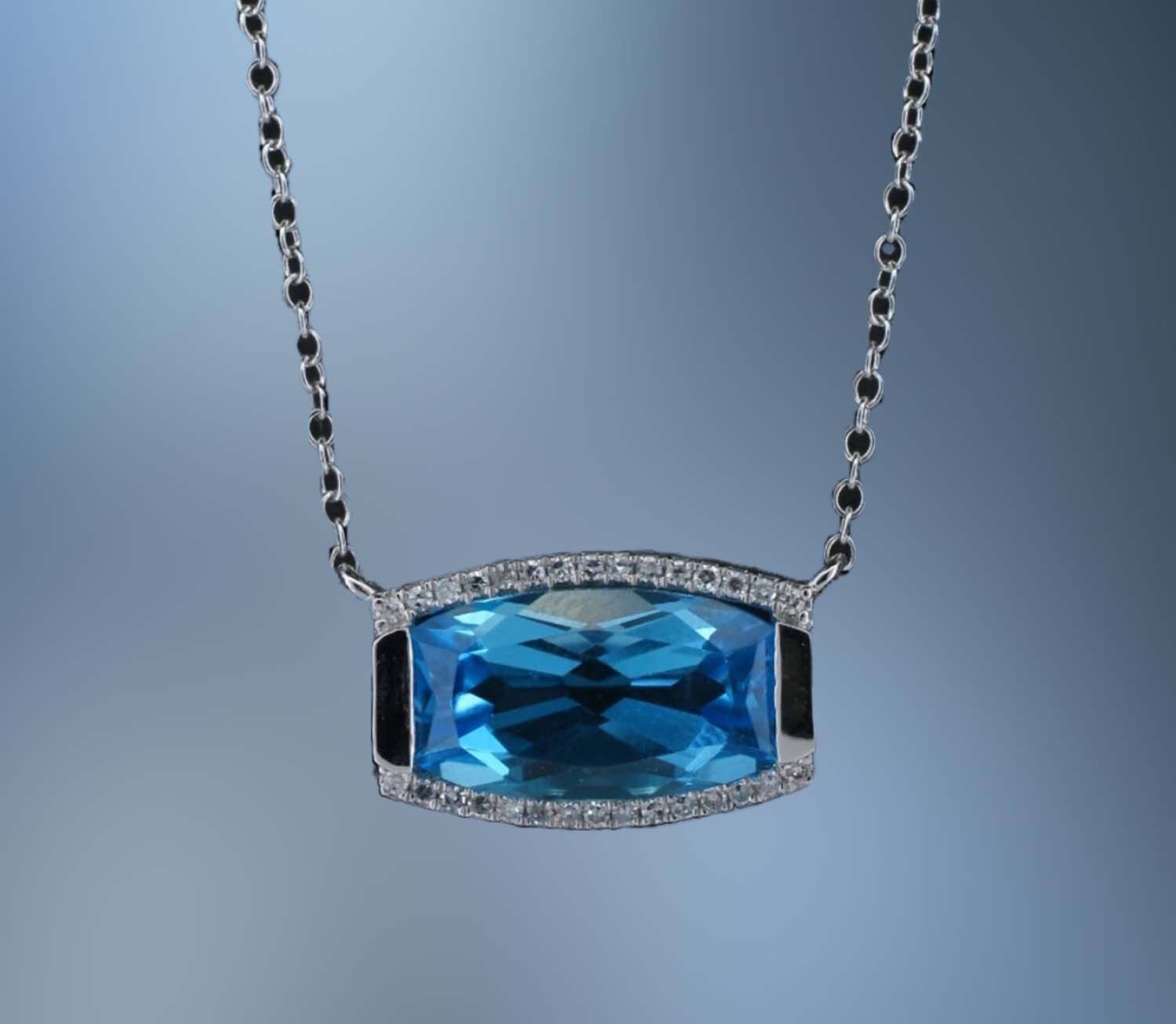 14KT WHITE GOLD PENDANT FEATURING (1) 3.82 CT. RECTANGULAR RADIANT BLUE TOPAZ AND (30) ROUND BRILLIANT CUT DIAMONDS TOTALING .09 CTS. ON AN 18 14KT WHITE GOLD PENDANT FEATURING (1) 3.82 CT. RECTANGULAR RADIANT BLUE TOPAZ AND (30) ROUND BRILLIANT CUT DIAMONDS TOTALING .09 CTS. ON AN 18" ADJUSTABLE CHAIN.