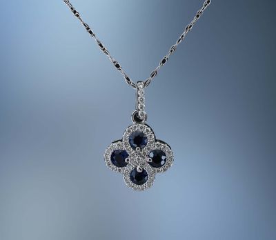 14KT WHITE GOLD SAPPHIRE AND DIAMOND PENDANT FEATURING 4 SAPPHIRES TOTALING .50 CTS AND 45 DIAMONDS TOTALING .20 CTS 14KT WHITE GOLD SAPPHIRE AND DIAMOND PENDANT FEATURING 4 SAPPHIRES TOTALING .50 CTS AND 45 DIAMONDS TOTALING .20 CTS