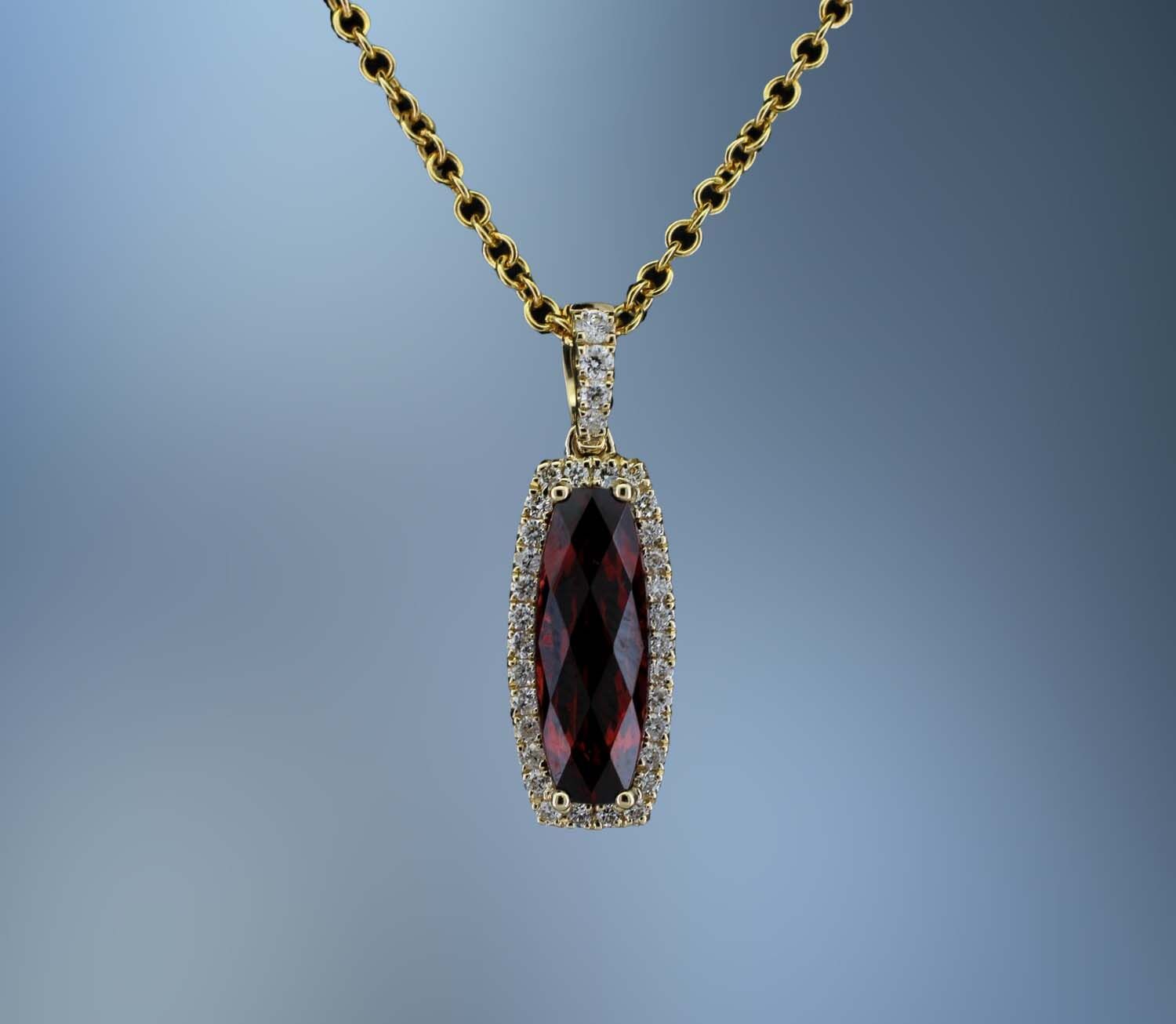 14KT YELLOW GOLD LADY'S PENDANT FEATURING ONE FANTASY CUT GARNET TOTALING 1.45 CTS.AND 34  ROUND BRILLIANT CUT  DIAMONDS TOTALING .19CTS