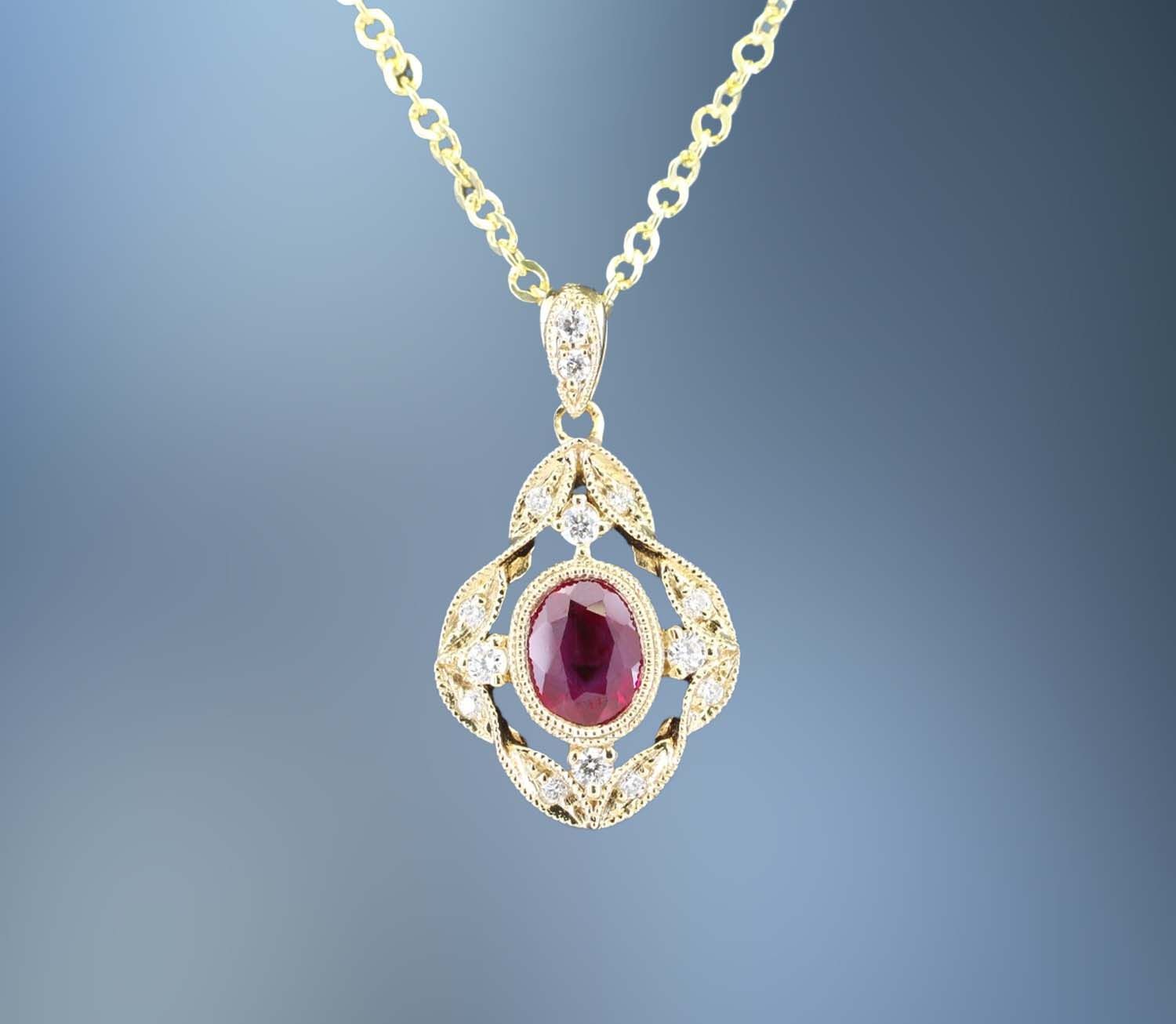 14KT YELLOW GOLD RUBY AND DIAMOND PENDANT FEATURING ONE .39 CT. OVAL BRILLIANT CUT RUBY AND 12 ROUND BRILLIANT CUT DIAMONDS TOTALING .09 CTS. 14KT YELLOW GOLD RUBY AND DIAMOND PENDANT FEATURING ONE .39 CT. OVAL BRILLIANT CUT RUBY AND 12 ROUND BRILLIANT CUT DIAMONDS TOTALING .09 CTS.