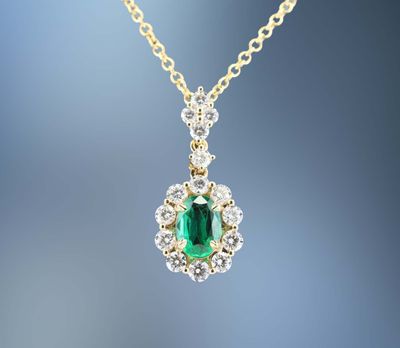 18 KARAT EMERALD AND DIAMOND PENDANT CONTAINING ONE OVAL SHAPED EMERALD WEIGHING 0.53 CARATS AND 15 ROUND BRILLIANT CUT DIAMONDS TOTALING 0.69 CARATS 18 KARAT EMERALD AND DIAMOND PENDANT CONTAINING ONE OVAL SHAPED EMERALD WEIGHING 0.53 CARATS AND 15 ROUND BRILLIANT CUT DIAMONDS TOTALING 0.69 CARATS