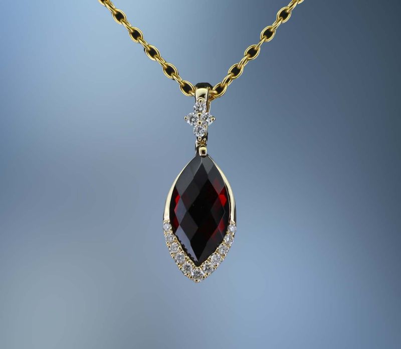 CM3980Y 14KT YELLOW GOLD DIAMOND & GARNET PENDANT FEATURING  .10 CTS OF ROUND BRILLIANT DIAMONDS & ONE MARQ CUT GARNET TOTALING 1.10 CTS