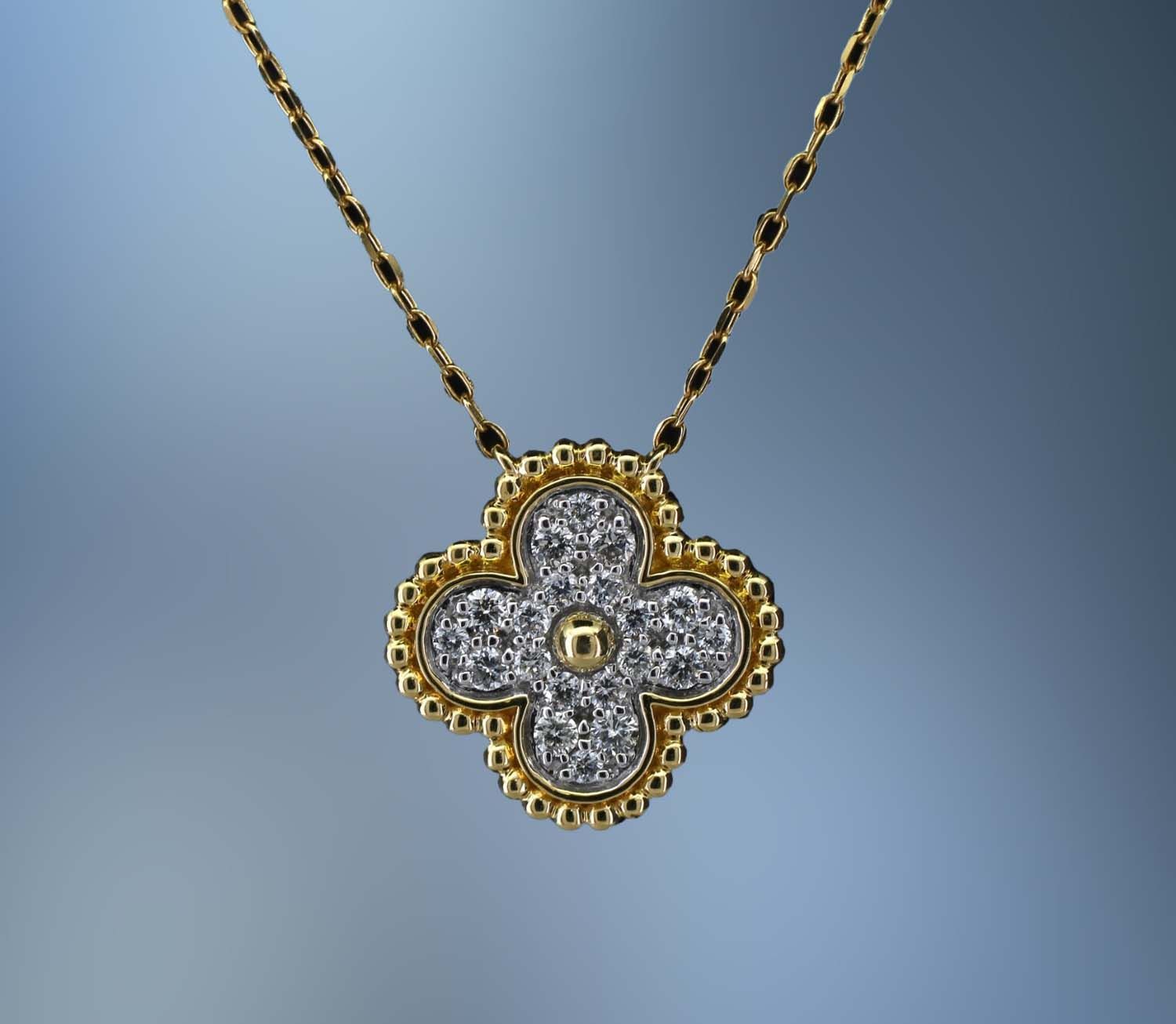 18KT YELLOW AND WHITE GOLD PENDANT FEATURING 20 ROUND BRILLIANT DIAMONDS TOTALING .26 CTS.