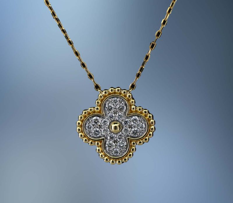 18KT YELLOW AND WHITE GOLD PENDANT FEATURING 20 ROUND BRILLIANT DIAMONDS TOTALING .26 CTS.