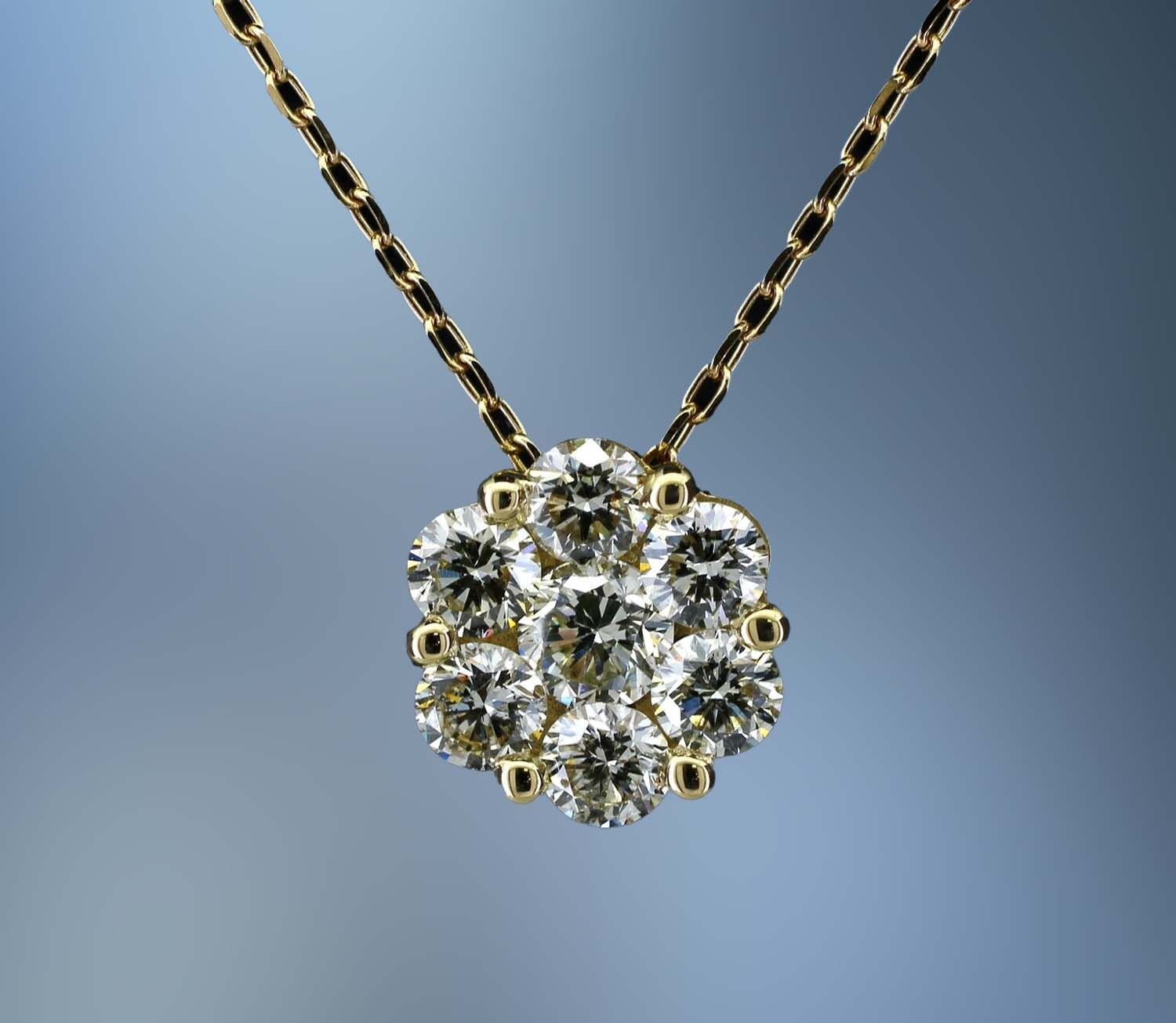18KT YELLOW GOLD PENDANT FEATURING 7 ROUND BRILLIANT DIAMONDS TOTALING 1.04 CTS.