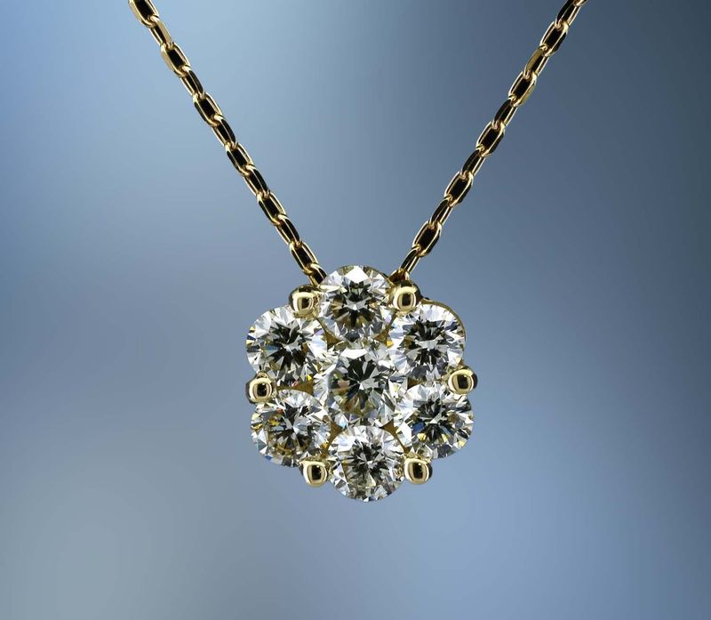 18KT YELLOW GOLD PENDANT FEATURING 7 ROUND BRILLIANT DIAMONDS TOTALING 1.04 CTS.