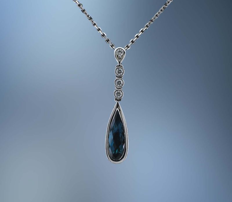 LADY'S 14KT WHITE GOLD  BLUE TOPAZ & DIAMOND PENDANT FEATURING 1 FANTASY CUT BLUE TOPAZ AND 8 ROUND BRILLIANT CUT DIAMONDS TOTALING  .15 CTS