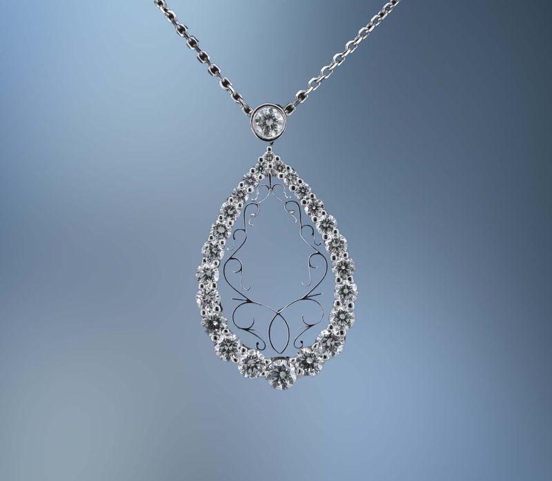 NJ4373 LADY'S 14KT WHITE GOLD PEAR SHAPED PENDANT FEATURING 25 ROUND BRILLIANT CUT DIAMONDS TOTALING 1.08 CTS  ON A 16" CHAIN.