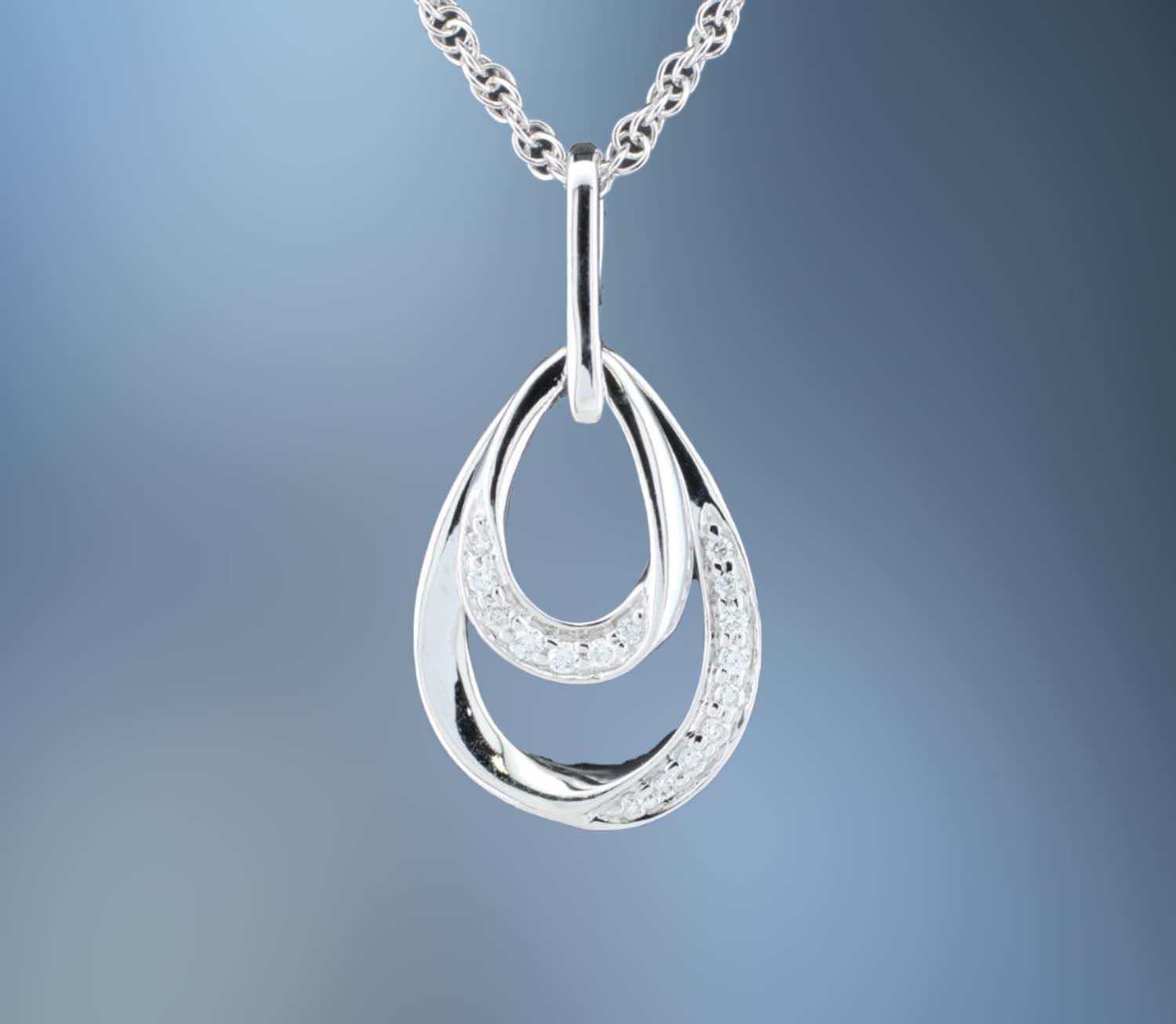 ONE 14KT WHITE GOLD LADIES DIAMOND PENDANT CONTAINING .07 CTS. OF NATURAL ROUND BRILLIANT CUT DIAMONDS ON AN 18 ONE 14KT WHITE GOLD LADIES DIAMOND PENDANT CONTAINING .07 CTS. OF NATURAL ROUND BRILLIANT CUT DIAMONDS ON AN 18" CHAIN WITH LOBSTER CLAW CLASP