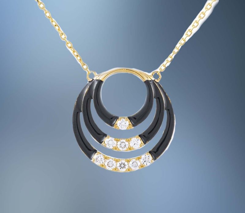 ONE 14KT YELLOW GOLD LADIES DIAMOND PENDANT CONTAINING .32 CTS. OF NATURAL ROUND BRILLIANT CUT DIAMONDS WITH BLACK ENAMELING ON AN 18" ADJUSTABLE CHAIN.