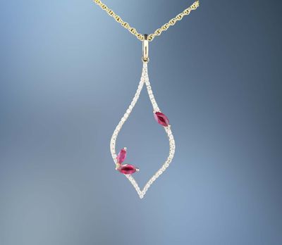 ONE 14KT YELLOW GOLD RUBY AND DIAMOND PENDANT CONTAINING .36 CTS OF MARQUISE SHAPE NATURAL RUBIES AND .56 CTS. OF NATURAL ROUND BRILLIANT CUT DIAMONDS ON AN 18 ONE 14KT YELLOW GOLD RUBY AND DIAMOND PENDANT CONTAINING .36 CTS OF MARQUISE SHAPE NATURAL RUBIES AND .56 CTS. OF NATURAL ROUND BRILLIANT CUT DIAMONDS ON AN 18" CHAIN WITH LOBSTER CLAW CLASP.