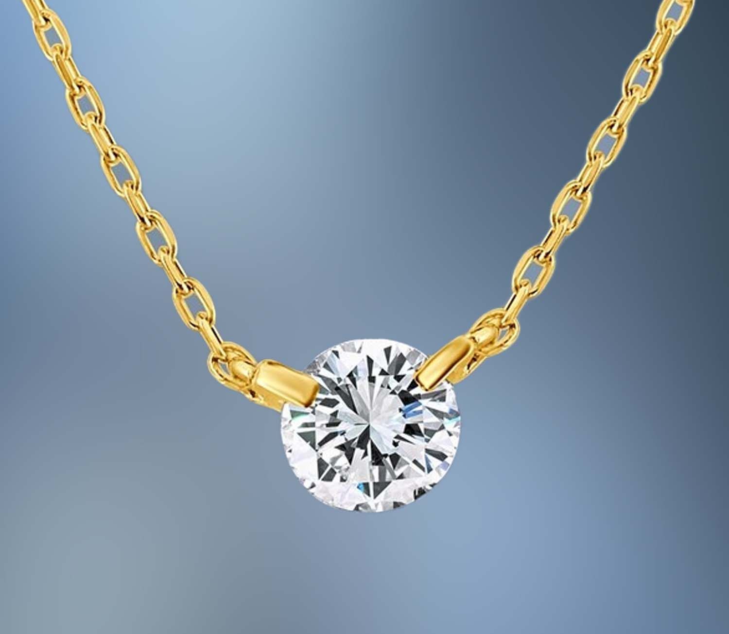 ONE 18KT YELLOW GOLD LADIES DIAMOND PENDANT CONTAINING ONE .50 CT NATURAL ROUND BRILLIANT CUT DIAMOND ON A 17 ONE 18KT YELLOW GOLD LADIES DIAMOND PENDANT CONTAINING ONE .50 CT NATURAL ROUND BRILLIANT CUT DIAMOND ON A 17" ADJUSTABLE CHAIN.