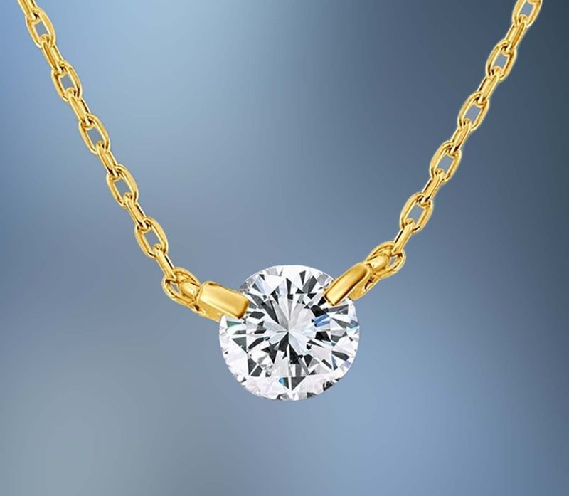 ONE 18KT YELLOW GOLD LADIES DIAMOND PENDANT CONTAINING ONE .50 CT NATURAL ROUND BRILLIANT CUT DIAMOND ON A 17" ADJUSTABLE CHAIN.