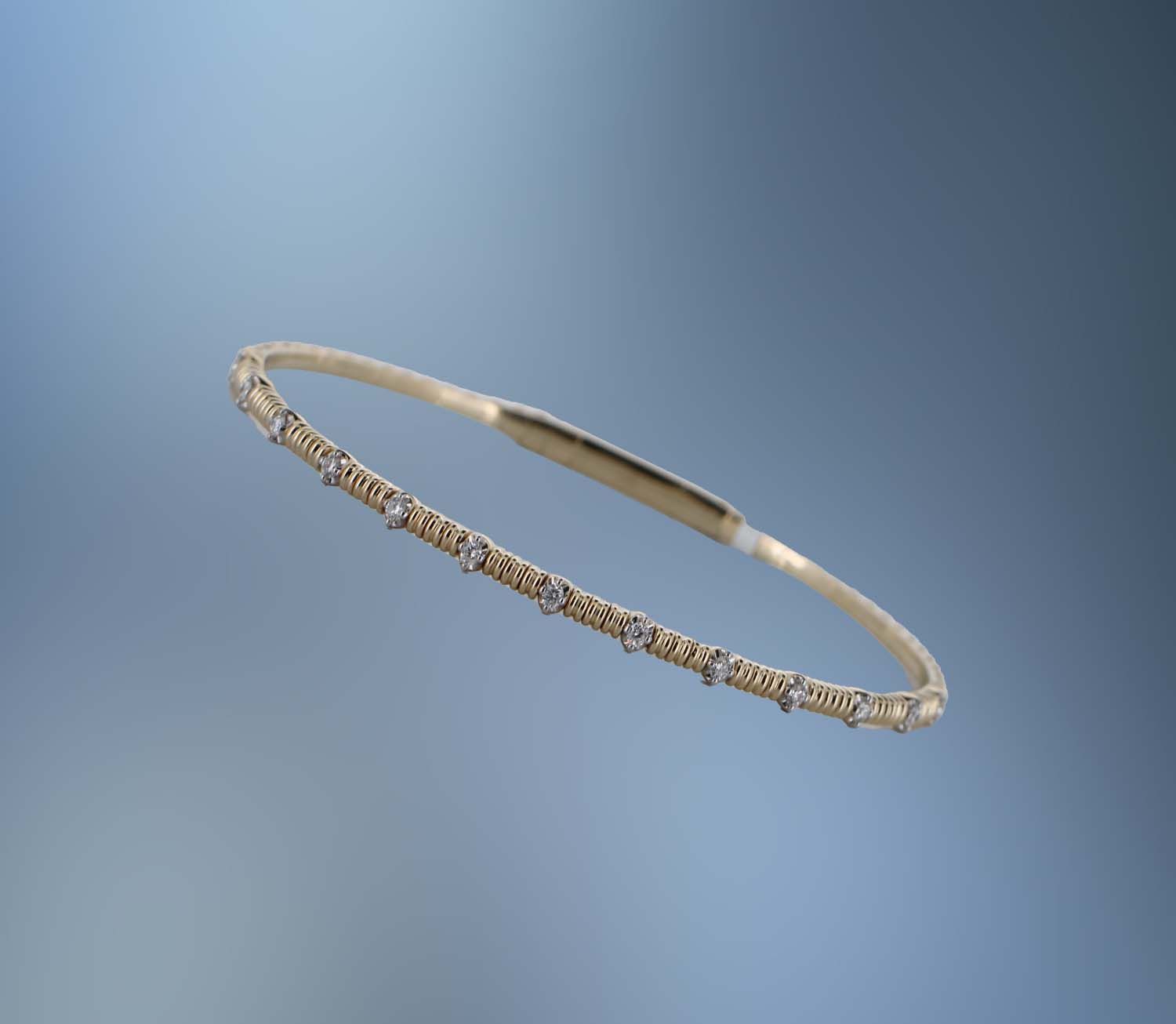 ONE 14 KT YELLOW GOLD FLEXIBLE BANGLE CONTAINING NATURAL ROUND BRILLIANT CUT DIAMONDS TOTALING .17 CT
