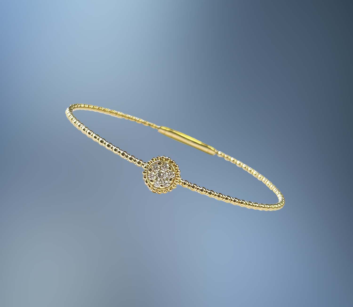ONE 14KT YELLOW GOLD FLEXIBLE BANGLE CONTAINING 7 NATURAL ROUND BRILLIANT CUT TOTALING .26 CTS