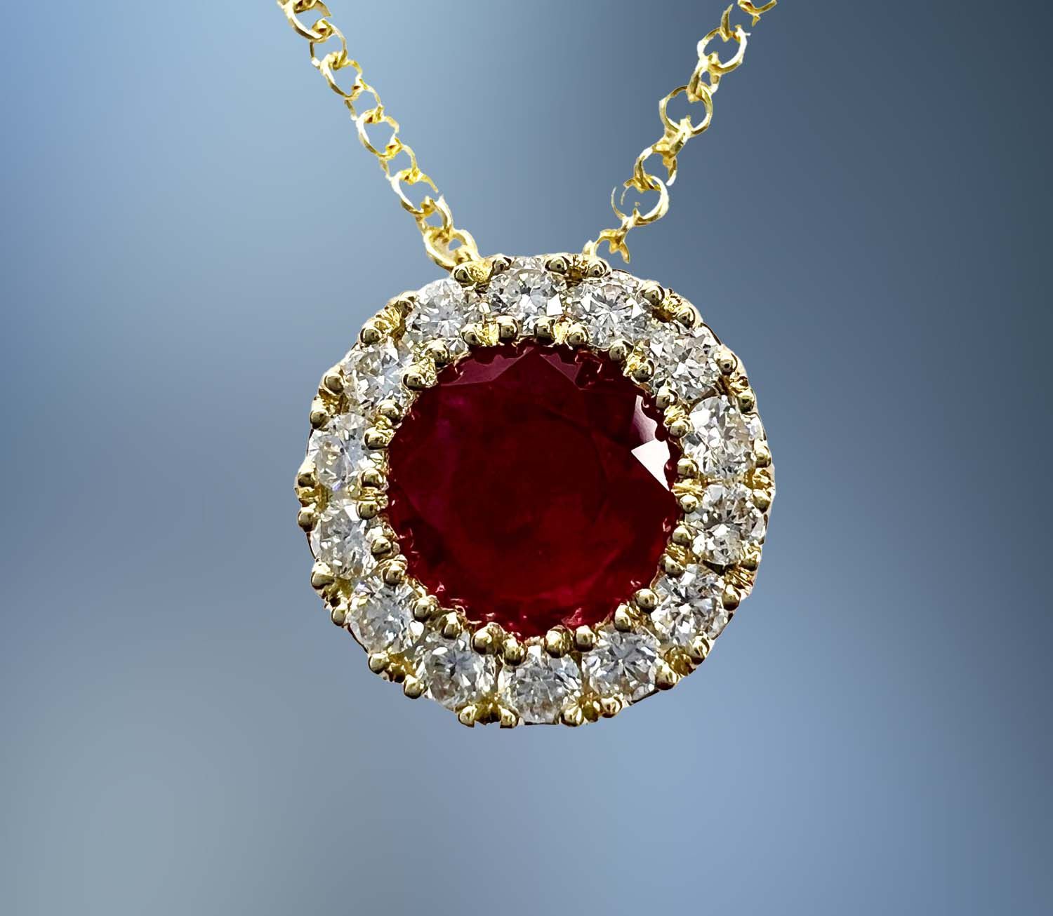 ONE 14KT YELLOW GOLD PENDANT CONTAINING ONE NATURAL ROUND FACETED RUBY TOTALING .53 CTS AND NATURAL ROUND BRILLIANT CUT DIAMONDS TOTALING .16 CTS ONE 14KT YELLOW GOLD PENDANT CONTAINING ONE NATURAL ROUND FACETED RUBY TOTALING .53 CTS AND NATURAL ROUND BRILLIANT CUT DIAMONDS TOTALING .16 CTS