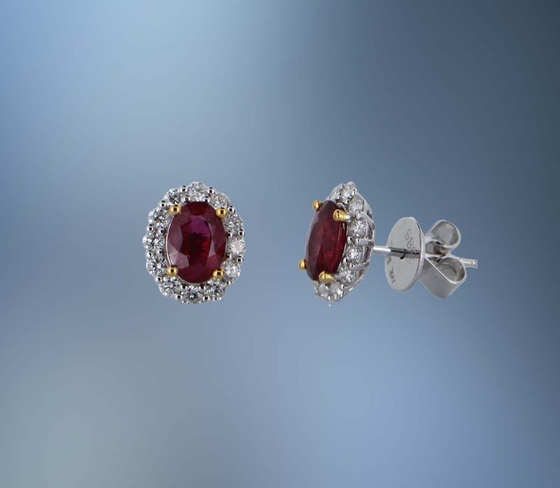ONE PAIR OF 14KT TWO TONED EARRINGS CONTAINING NATURAL OVAL FACETED RUBIES TOTALING 1.83 CTS AND 24 NATURAL ROUND BRILLIANT CUT DIAMONDS TOTALING .57 CTS