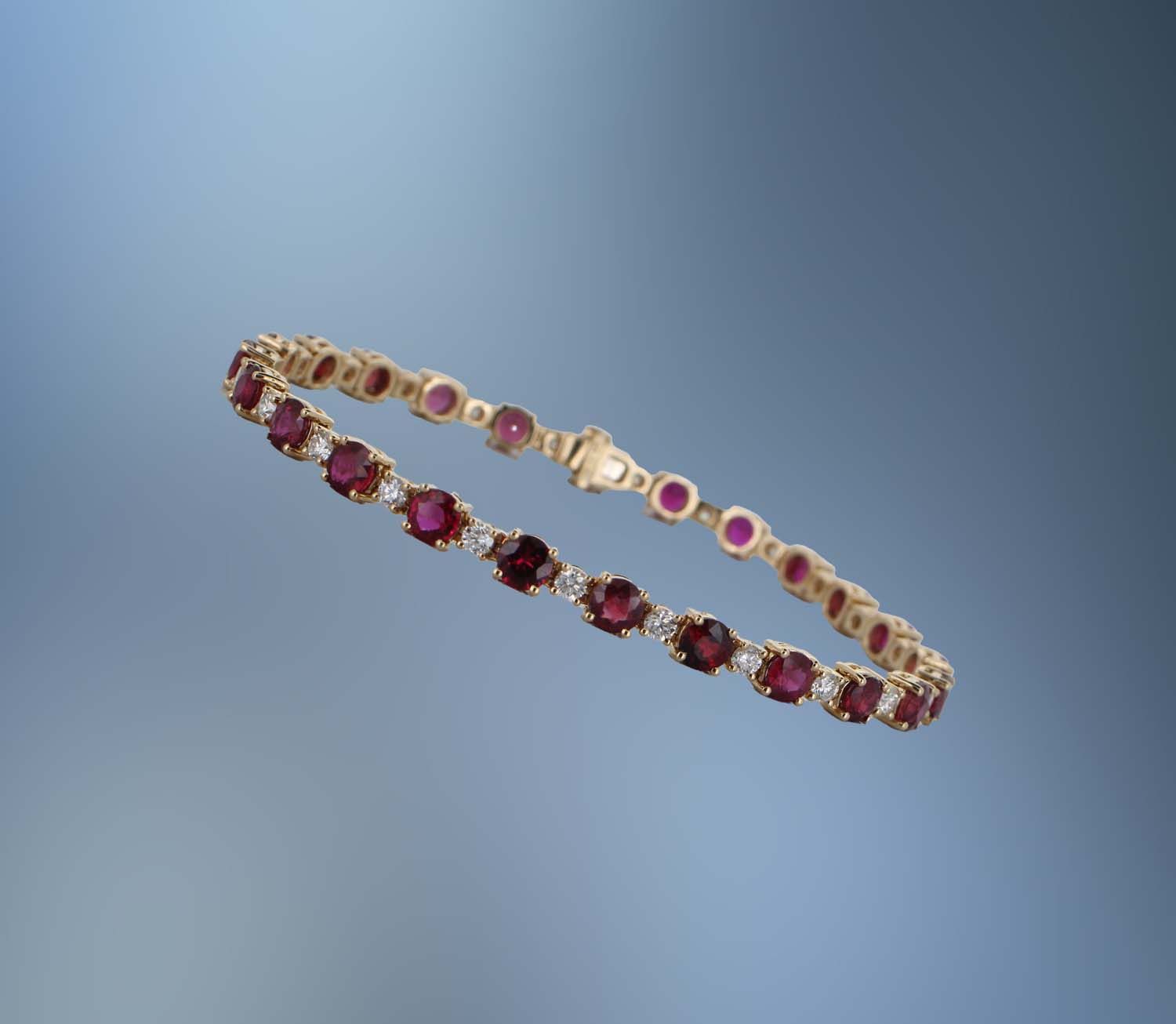 ONE 18 KT YELLOW GOLD NATURAL DIAMOND AND RUBY TENNIS BRACELET CONTAINING 24 ROUND FACETED RUBIES TOTALING 7.90 CTS AND 24 ROUND BRILLIANT CUT DIAMONDS TOTALING 1.44 CTS ONE 18 KT YELLOW GOLD NATURAL DIAMOND AND RUBY TENNIS BRACELET CONTAINING 24 ROUND FACETED RUBIES TOTALING 7.90 CTS AND 24 ROUND BRILLIANT CUT DIAMONDS TOTALING 1.44 CTS